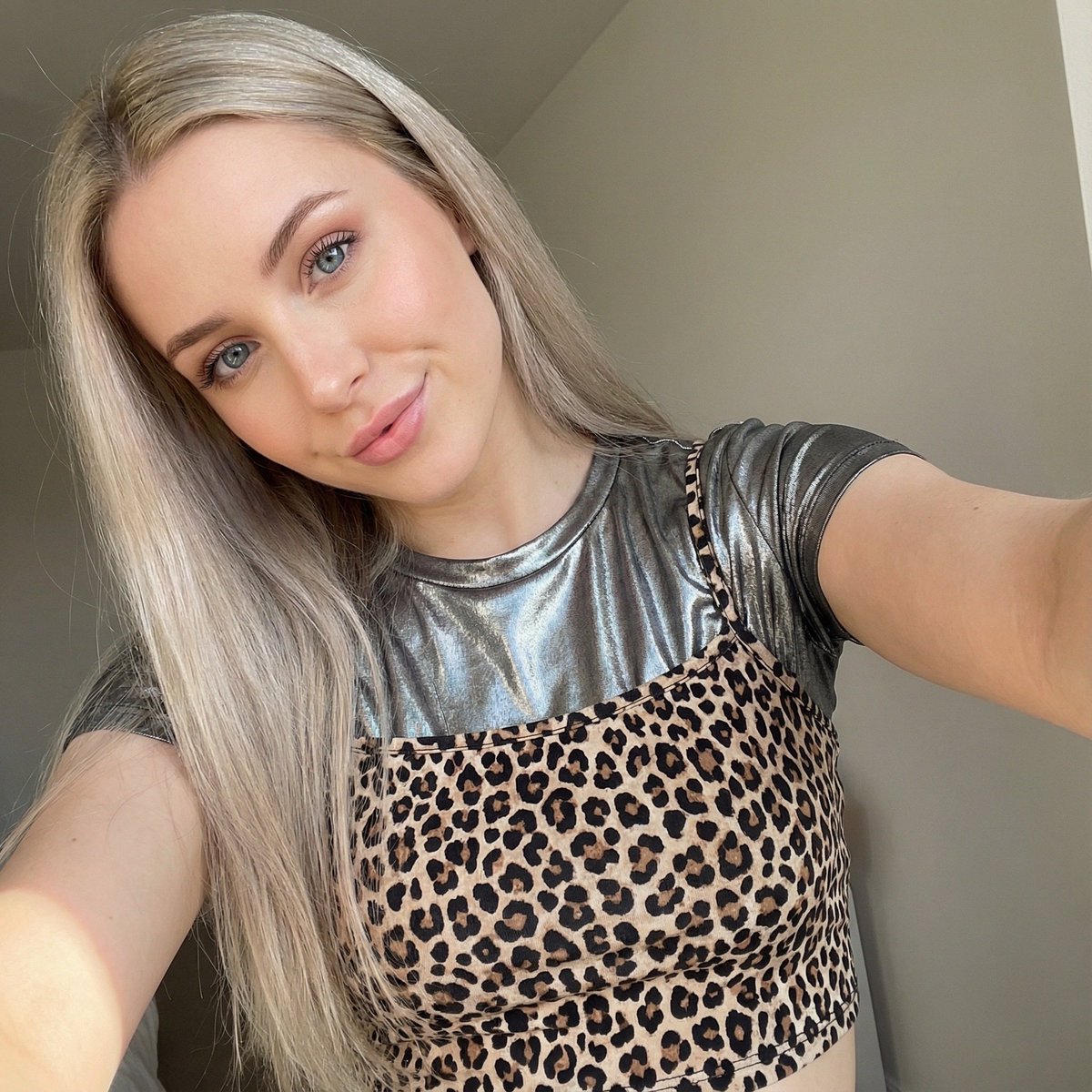 Close-up Selfie of a Woman in Leopard Print and Metallic Shirt 2