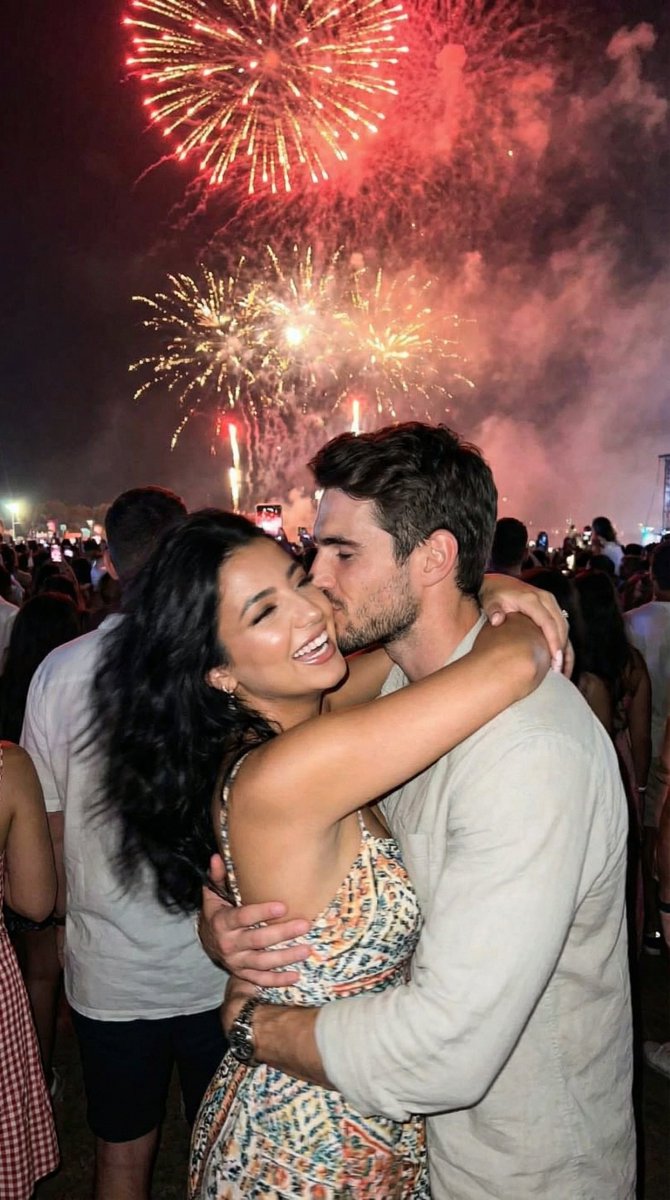 Candid Smartphone Snapshot of Festival Kiss with Fireworks
