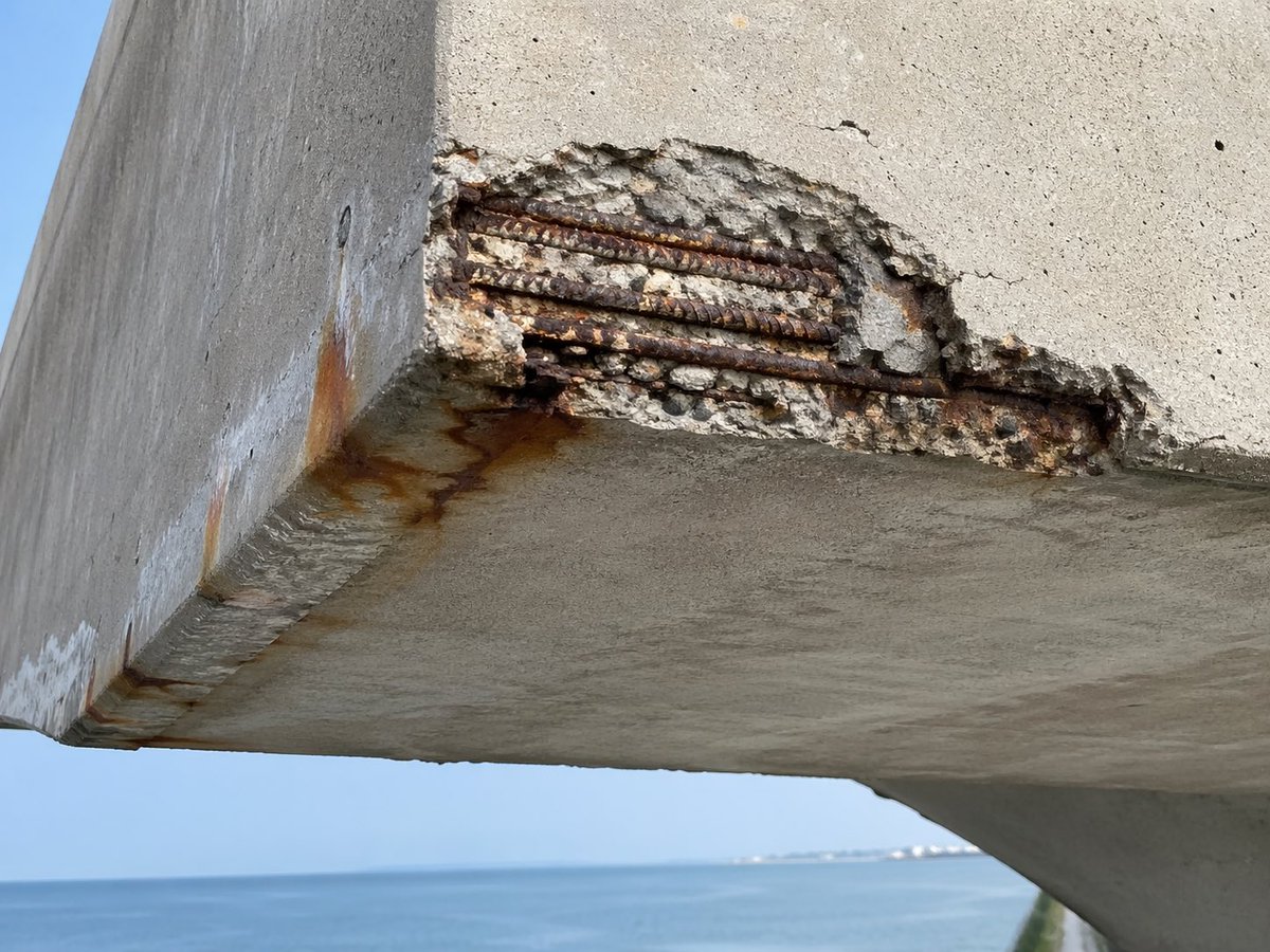 Coastal Reinforced Concrete Salt Damage Qwen Image prompt example: This prompt generates a realistic inspection-style photo of chloride corrosion and concrete spalling on a...
