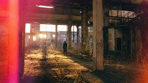Lone Figure in Abandoned Warehouse