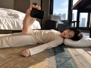 Foot-Held Selfie in Hotel Room