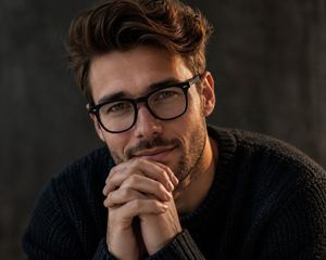 Masculine Contemplative Editorial Portrait — Create a Close up cinematic editorial portrait of me, angled slightly with head tilted forward, gazing at the camer
