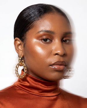 Fashion Portrait With Face Color Block — Create a high-fashion studio portrait of a {argument name="model description" default="woman with medium-deep brown ski