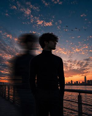 Motion Blur Sunset Portrait — A cinematic low-angle portrait of a {argument name="subject" default="young man"} standing on a {argument name="location" default=