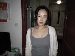 Candid Apartment Doorway Portrait — Create a raw photorealistic snapshot of {argument name="subject" default="an East Asian woman in her late 20s to early 30s"}