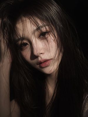 Cinematic Low-Key East Asian Portrait — an ultra-realistic cinematic close-up portrait of a {argument name="subject" default="young East Asian woman"}. She has 