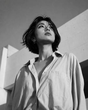 Low-Angle Fashion Lookbook Style — Low-angle fashion editorial shot of an {argument name="subject" default="East Asian woman"} with a {argument name="hairstyle"
