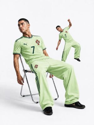 Luxury Sports Fashion Studio Editorial — Ultra-realistic luxury sports fashion editorial, Cristiano Ronaldo seated casually on a minimalist c…