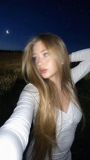 Night Flash iPhone Selfie with Motion Blur — Ultra-realistic lifestyle selfie photograph.

Do not change the woman's face. Preserve 100% facial i…