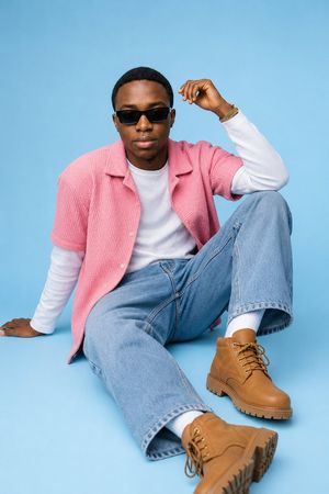 African Male Fashion Editorial — Use the uploaded image as the facial identity reference for the subject. Preserve his natural facial structure, skin tone, hair