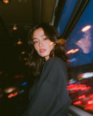 Cinematic Night Bus Double Exposure — Create a photorealistic cinematic portrait of a {argument name="subject" default="young woman"} sitting inside a moving ci